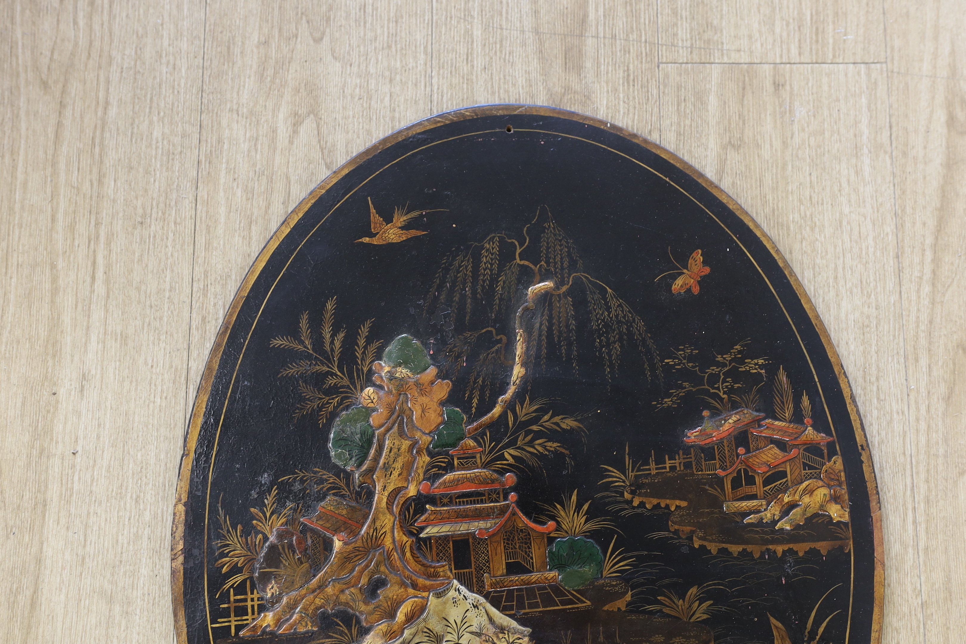 A Japanese oval lacquer panel, 66cm long